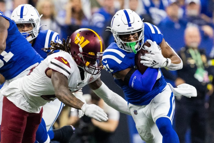Oct 30, 2022; Indianapolis, Indiana, USA; Indianapolis Colts running back Nyheim Hines (21) runs the ball while Washington Commanders safety Bobby McCain (20) defends in the second quarter at Lucas Oil Stadium. Mandatory Credit: Trevor Ruszkowski-USA TODAY Sports